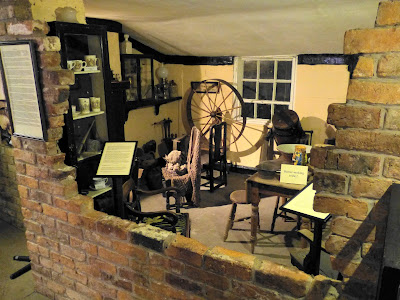 A room depicting a household scene with a spinning wheel set up by my mother-in-law in the blacksmith's shop museum, Gretna Green (2015)