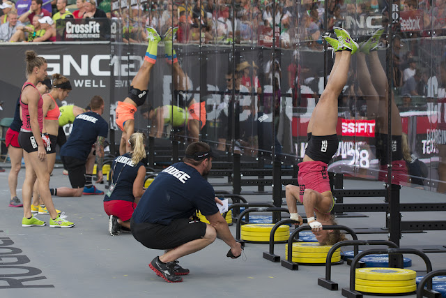 Women competing and performing handstand pushups at the 2012 Reebok CrossFit Games 