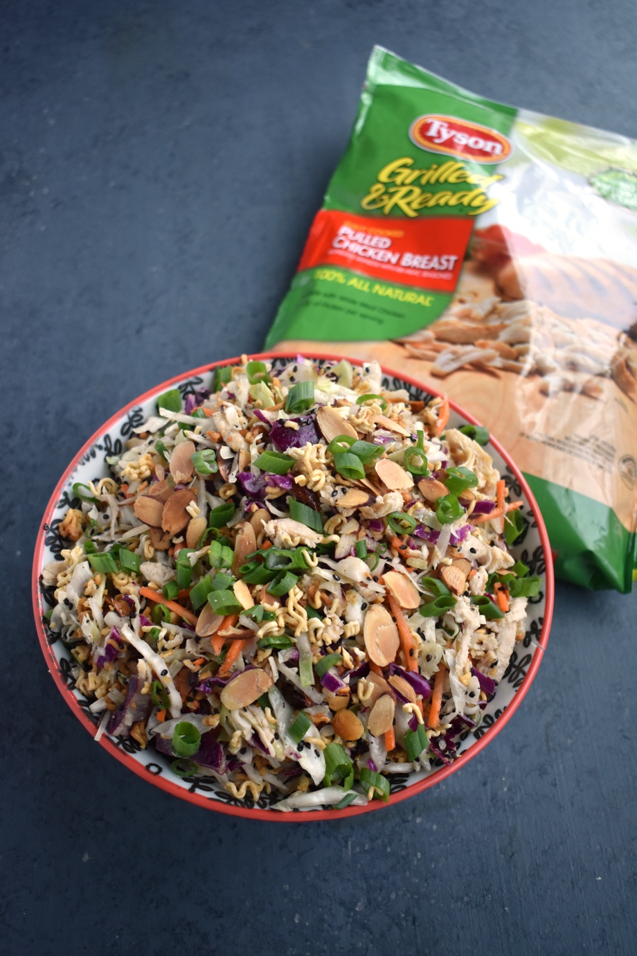 Asian Chicken Ramen Noodle Salad is crunchy and tangy with cabbage, carrots, green onion, almonds, chicken and an Asian vinaigrette that is perfect for meal prep and is packed with protein and veggies! #salad #asian #chicken #healthy #mealprep #cleaneating #lunch Asian Ramen Noodle Salad