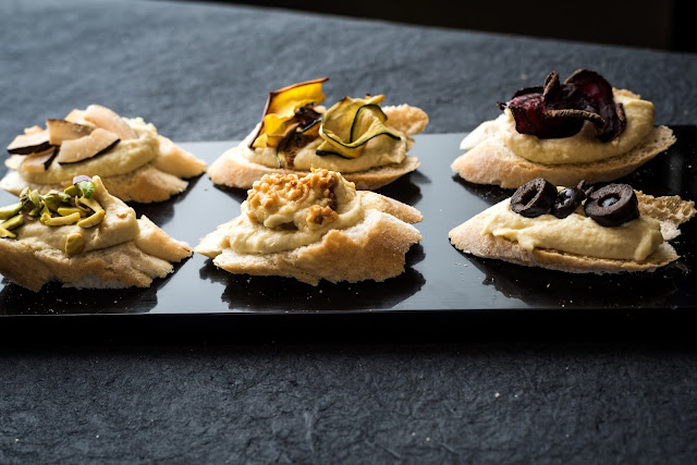 Hummus crostini with assorted toppings Hummus crostini with assorted toppings