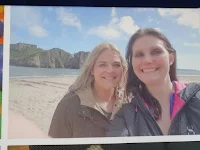 two woman taking selfie at beach 