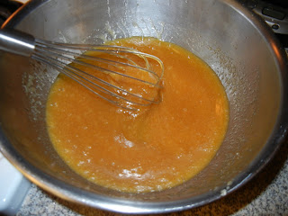 butter and brown sugar in a metal bowl with a metal whisk 