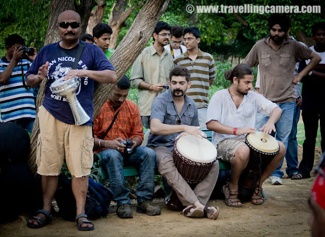 Delhi Drum Circle @ Deer Park, Hauz Khas Village, Delhi, INDIA  : Posted by VJ SHARMA on www.travellingcamera.com : Thanks to Facebook that I got to know about this event and I moved towards this wonderful place called Deer Park in Hauz Khas Village !!! Check out this PHOTO JOURNEY through various drum beats, dance moves, other musical instruments, Enthusiastic people and loads of Fun...Although I don't know many of these folks but all of them were rocking... I was there with Camera but hardly I was able to focus on Photography because their music was amazing and I preferred to enjoy the music instead...Although I don't know many of these folks but all of them were rocking... I was there with Camera but hardly I was able to focus on Photography because their music was amazing and I preferred to enjoy the music instead...It was just the beginning when people started enjoying the music to the core and dancing at the place they were sitting...Initially these folks with drums were settled on the benches arrnged in a Circle and over the time they started moving around & dancing with their drums...