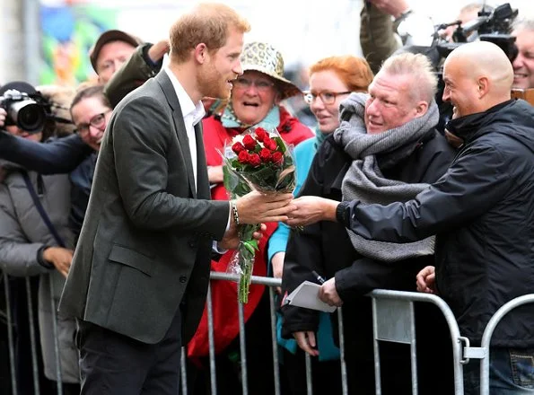 Prince Harry receives flowers as he arrives to a Start-Up Business event at KPH Projects in Copenhagen