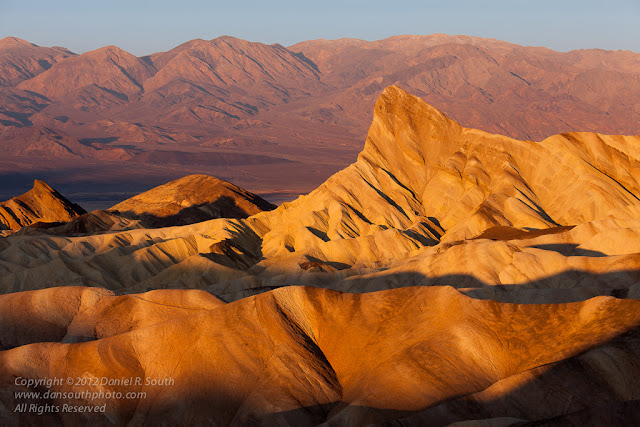 a photo of manley's beacon from zabriskie point at sunrise in death valley