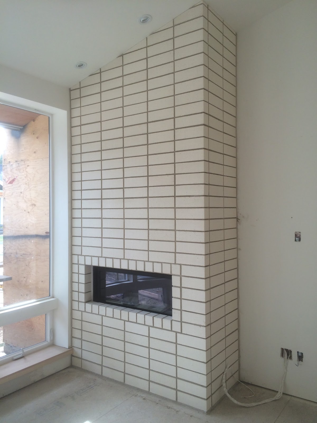 BOISINEAU MASONRY Stacked Bond Brick Fireplace in Northwest CRossing