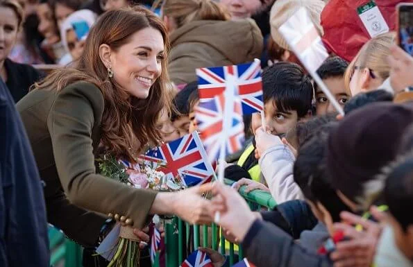 Kate Middleton wore a green Alexander McQueen coat, a print dress by Zara, Zeen ceramic earrings and Aspinal of London Mayfair bag