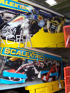 Photograph of Hornby Scalextrcis Lorry with a before; graphics being removed and after; full colour printed graphics applied.