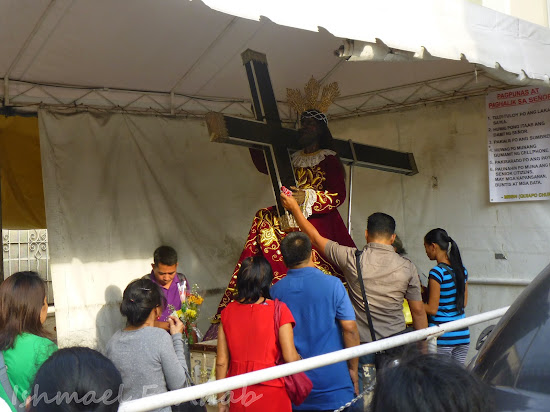 Devotees touching the replica of the Black Nazarene