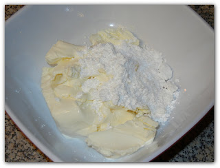 cream cheese and powdered sugar in a white bowl 
