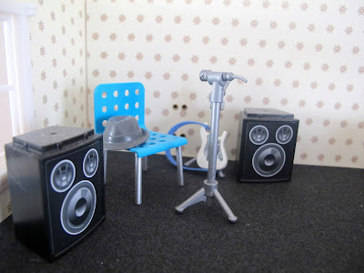 Band equipment set up in the corner of the first floor of a half-built Lundby dolls' house.