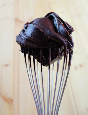 whisk with dark chocolate ganache style frosting