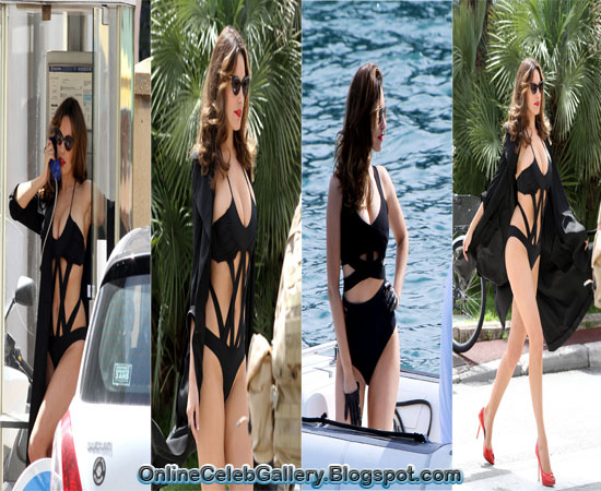 Kelly Brook squeezes into an indecent black swimsuit for phone booth photo shoot