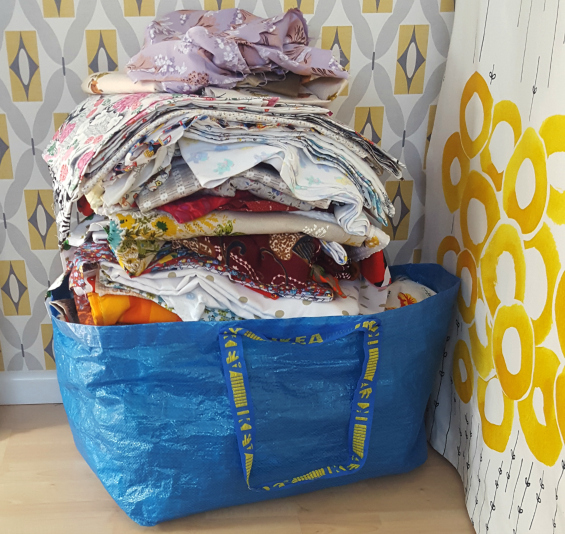 big blue Ikea bag of fabric for donation