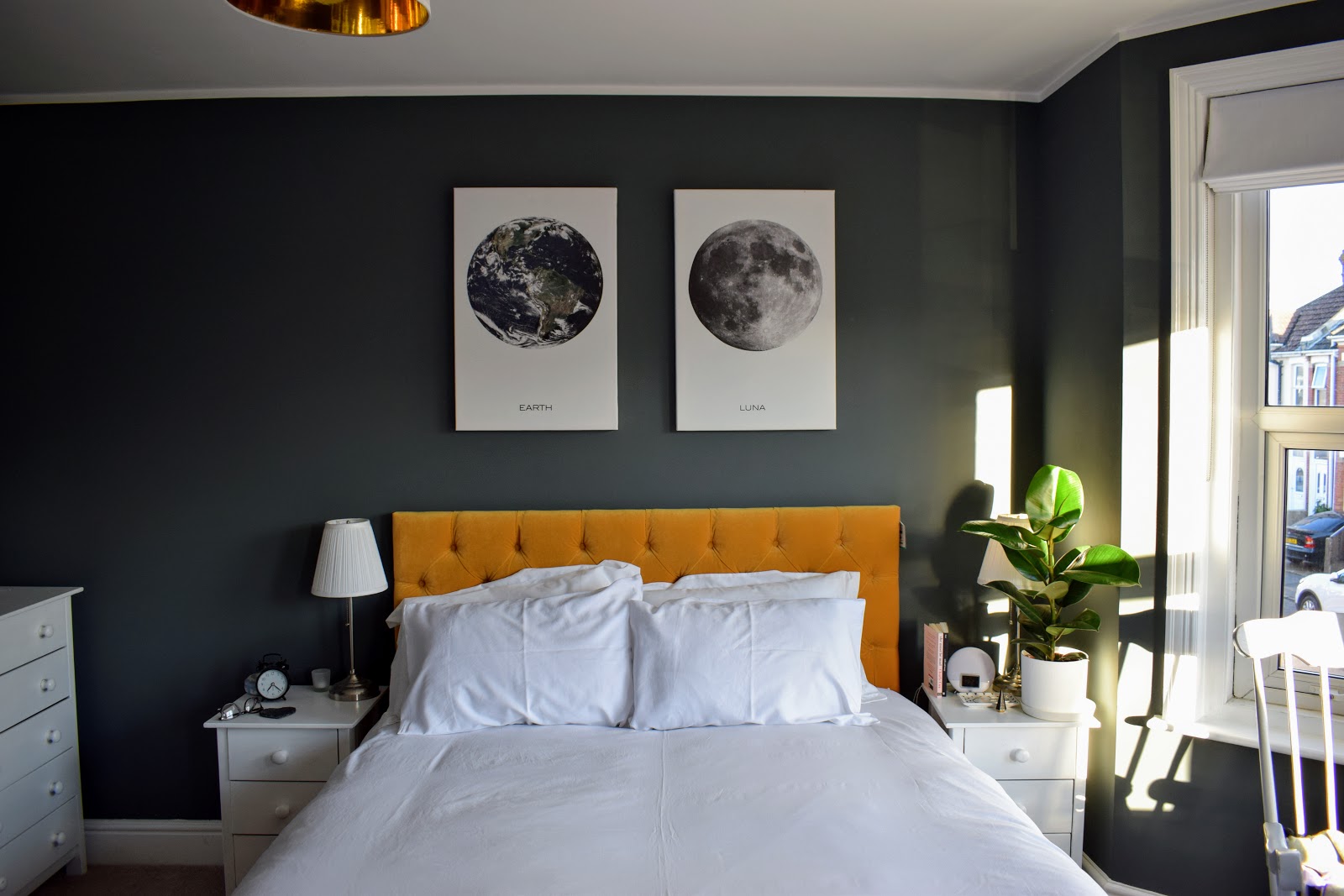 Dark grey bedroom with mustard yellow bed walls in Farrow and Ball