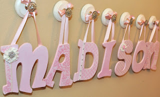 custom letters decors hanging on wall baby letters for nursery wall with pink tape stringed cork materials good typography design simple concept