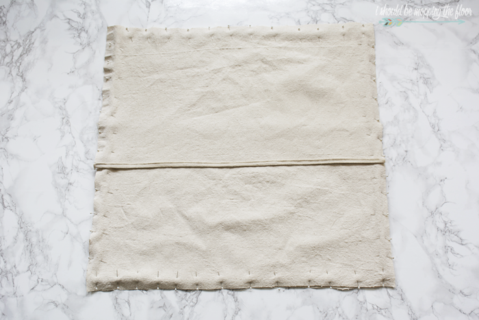 How to Make a Drop Cloth Envelope Pillow Cover | Simple beginning sewing project with step-by-step photo tutorial. These pillow covers are perfect to give ordinary pillows a festive look for the holidays.