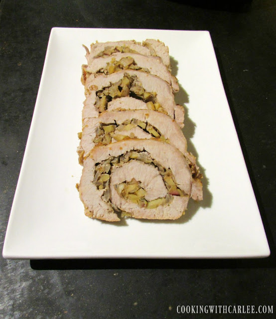 Pork loin stuffed with apples and rosemary makes for one delicious dinner. It is easier to assemble than you'd think too! slices of pork loin rolled around apple filling on serving platter