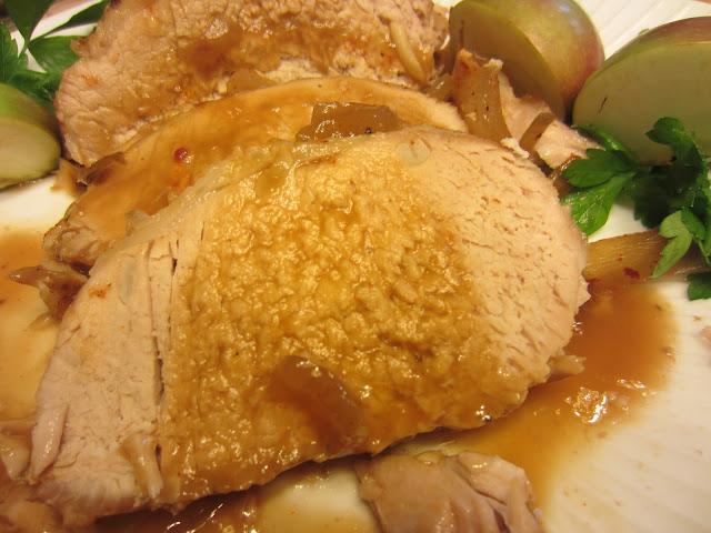 slice of pork loin on plate with gravy