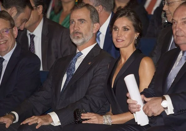 Queen Letizia wore HUGO BOSS V neck jumpsuit with satin trims. Magrit pumps, diamond earrings and baracelet