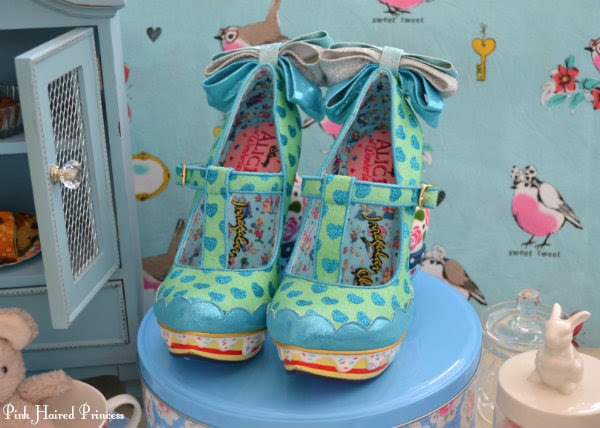 Irregular Choice Alice My Cup Of Tea shoes front front view of Irregular Choice Alice My Cup Of Tea shoes with cakes and tea party themed background