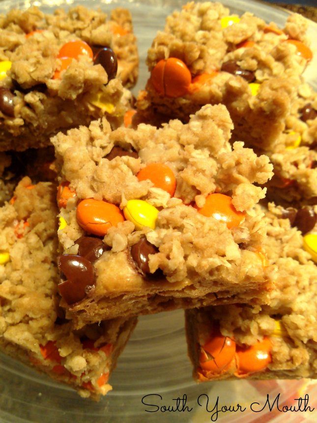 Reese’s Peanut Butter Oatmeal Bars! Peanut butter fudge stuffed oatmeal bars topped with Reese's Pieces candies. A perfect recipe for fall or Halloween!