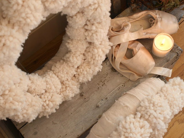 Cozy woolly white pom pom wreaths, pink pointe shoes, and vintage box