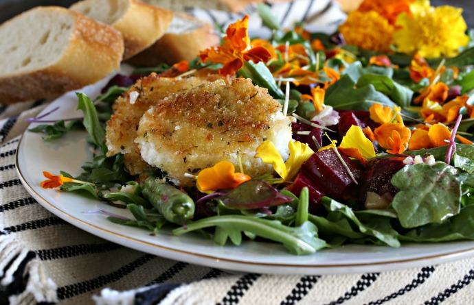 Salad with baby arugula, roasted beets, French green beans, edible flowers and fried goat cheese.