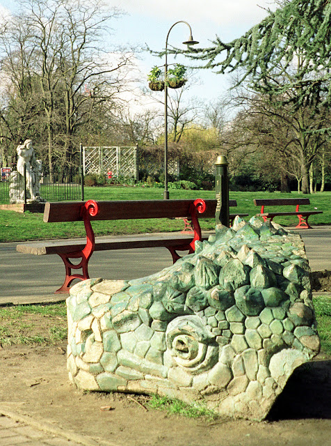 Crystal Palace Park, 1990s. Spare dinosaur head in the foreground. Crystal Palace Park, 1990s. Spare dinosaur head in the foreground.
