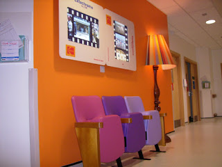 Row of stylish and comfortable waiting room chairs in a hospital corridor
