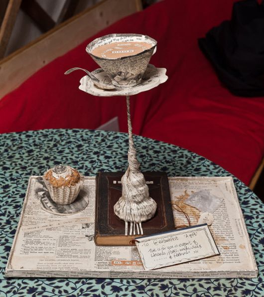 paper sculpture of tea cup and cupcake on a book