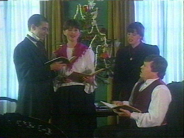 Marjorie, Lisa and Bob caroling in the parlour