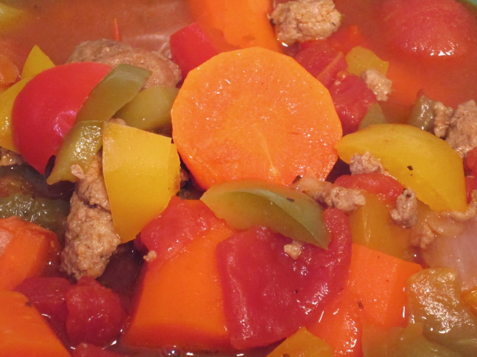 Carrots, bell peppers, tomatoes, and ground turkey in a chicken broth.