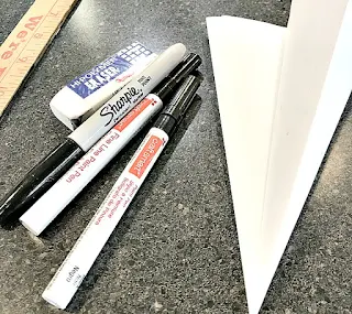 sharpie, butcher paper, and a ruler to create the clock face on a cheese box