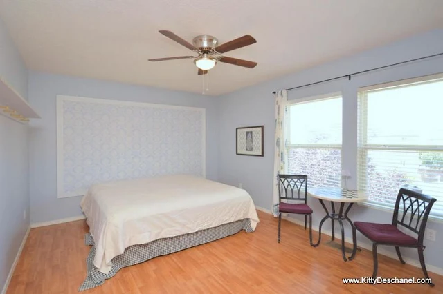 blue bedroom with wallpaper headboard