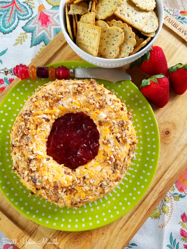 Pecan Cheddar Cheese Ring with Strawberry Preserves | Rosalynn Carter’s vintage appetizer recipe for a pecan and cheddar cheese ring with a slight hint of heat with strawberry preserves in the center served with crackers.