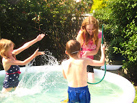 children playing in pool with mum