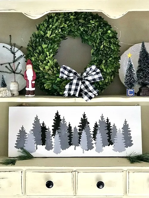 grey tree painting in a hutch with shelves