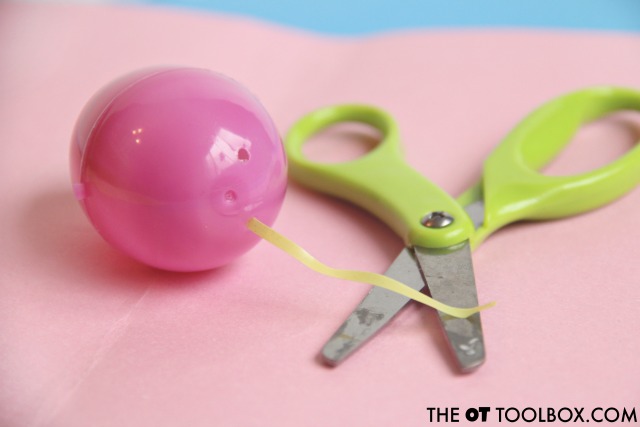 Kids will love to use a plastic Easter egg and Easter grass in this scissor skills Easter activity with kids. Easter themed scissor skills Easter activity
