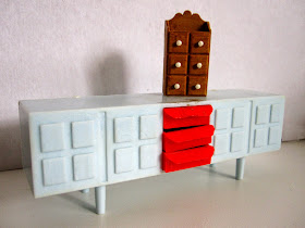 Modern dolls' house miniature plastic sideboard and spice cabinet.