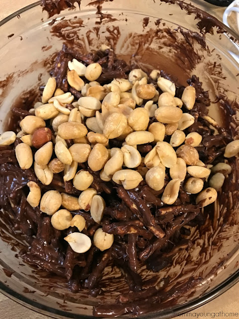 adding peanuts to chocolate haystacks
