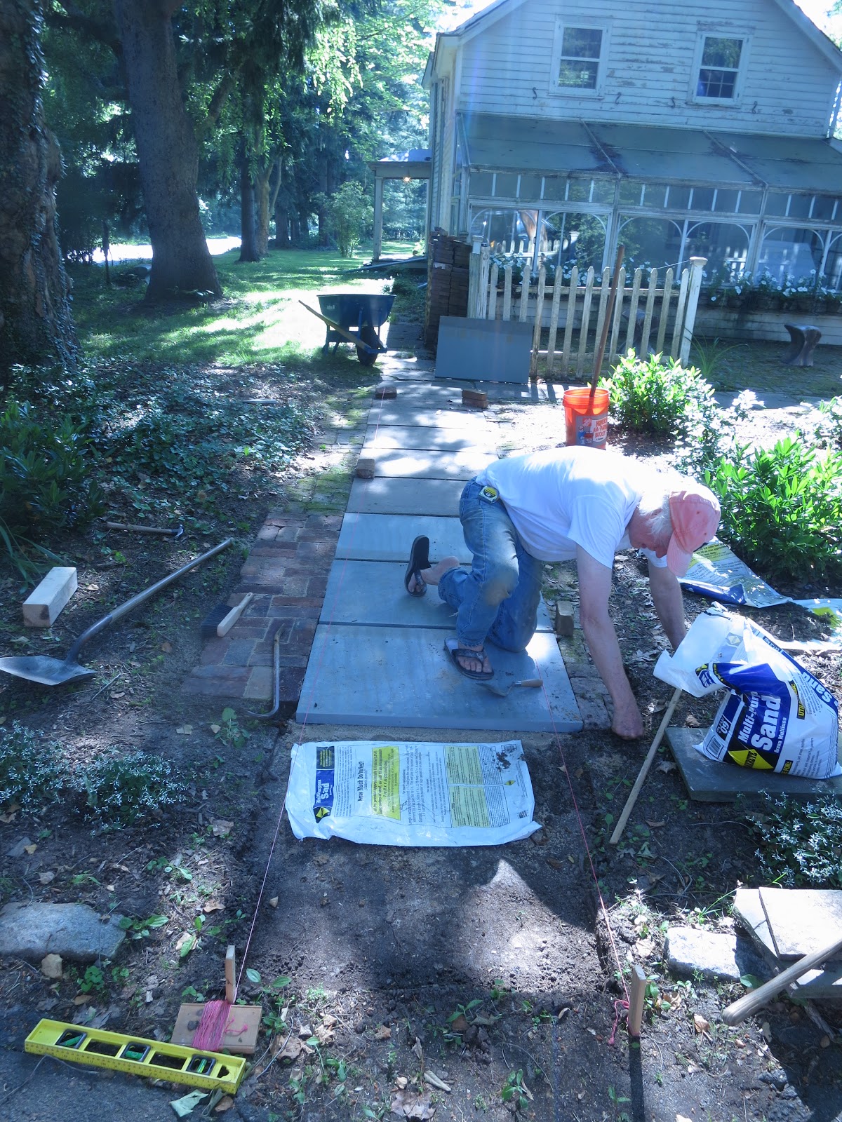 An Old Farm Laying A Flagstone Path