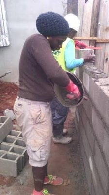 Dignity in labour: Woman seen building a fence