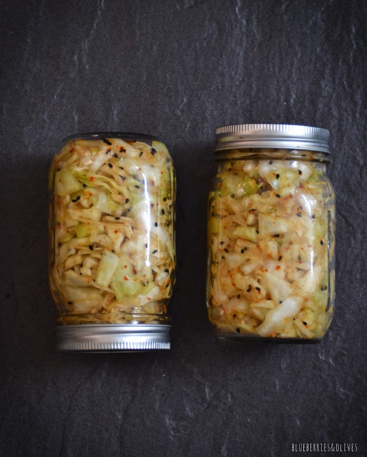 2 TARROS DE CRISTAL CERRADOS CON KIMCHI, FONDO NEGRO PIZARRA