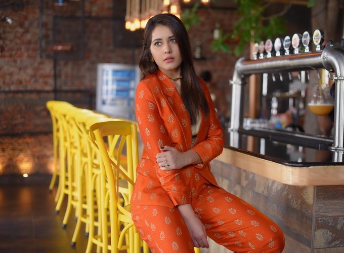 Raashi Khanna latest Photo Shoot Stills In Long Hair Orange Dress