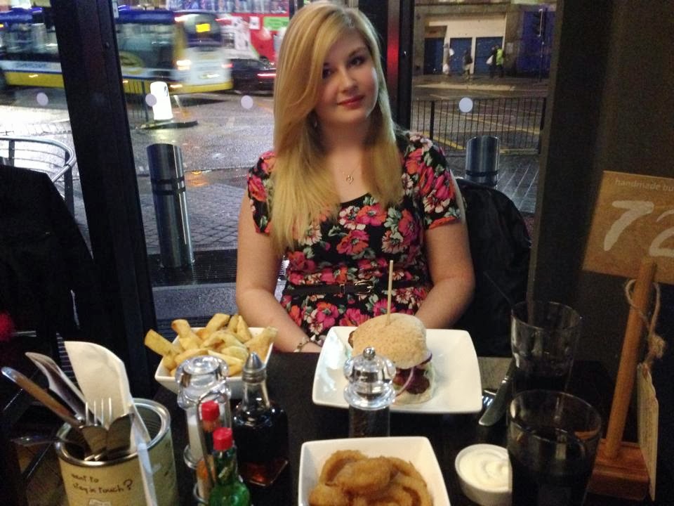 myself all dressed up in a pink playsuit also sitting at the table in front of my food and drink