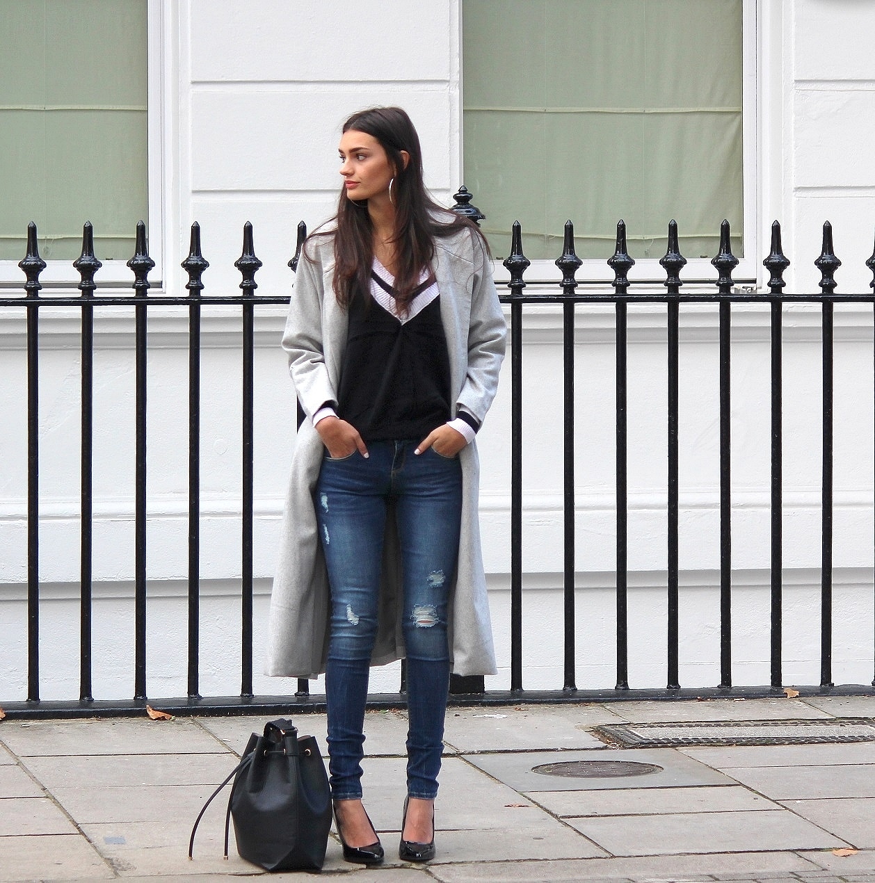 peexo fashion blogger wearing distressed denim and longline coat
