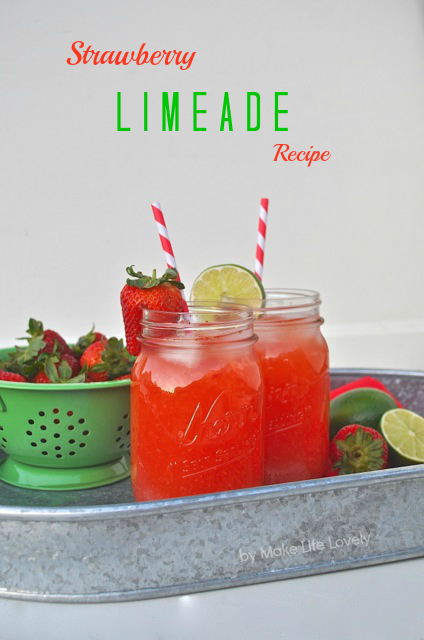 red drinks with fruit wedges in mason jars