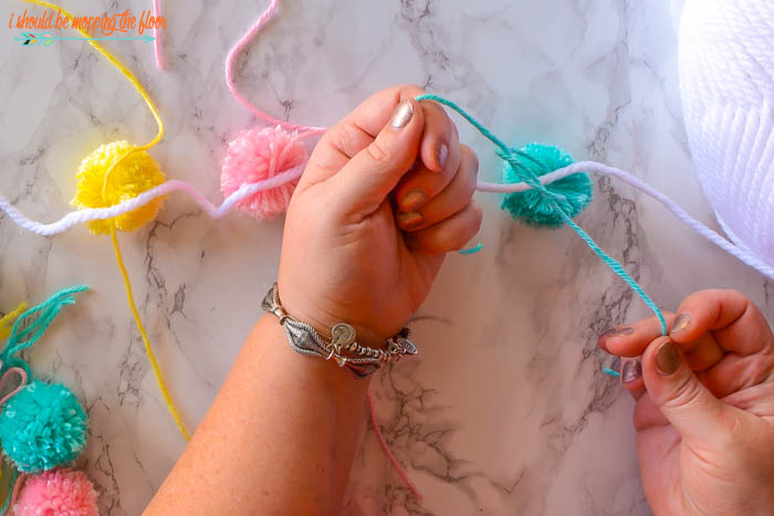 How to Make a Pom Pom Garland | Follow this easy tutorial to make a fun and fluffy yarn garland in minutes.