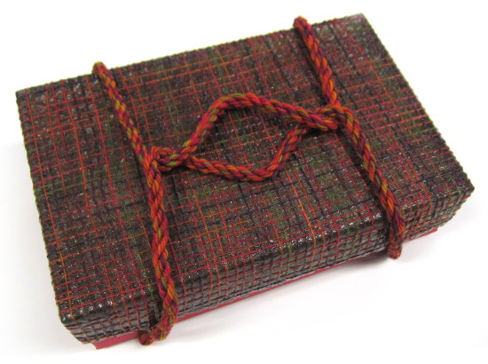 The woven box, sealed with Mod Podge, and handle